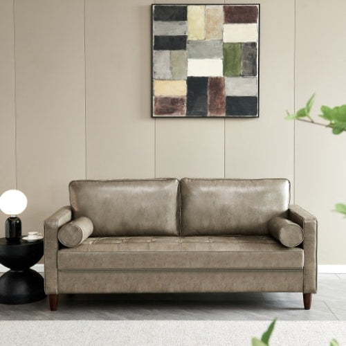 Modern mid-century khaki vegan leather sofa in a living room setting