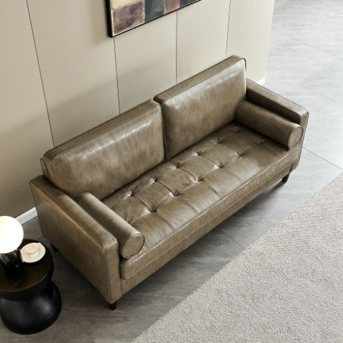 Modern mid-century khaki vegan leather sofa in a living room setting