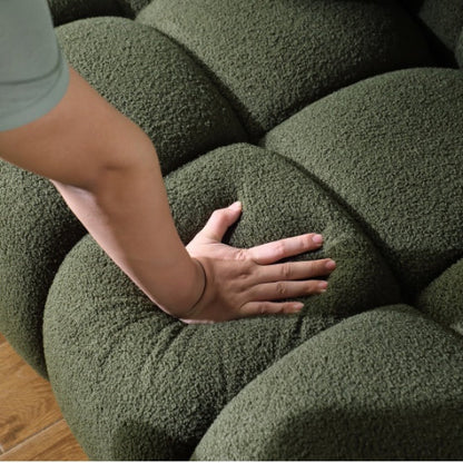 Elegant green bouclé 3-seater sofa with high-density foam cushions and two pillows for extra support. Perfect for adding style and comfort to any room.