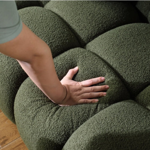 Elegant green bouclé 3-seater sofa with high-density foam cushions and two pillows for extra support. Perfect for adding style and comfort to any room.