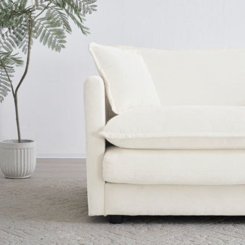 White chenille loveseat sofa with cushions on a wooden floor