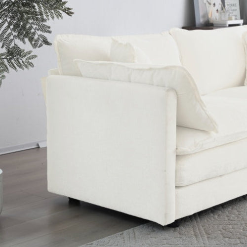 White chenille loveseat sofa with cushions on a wooden floor