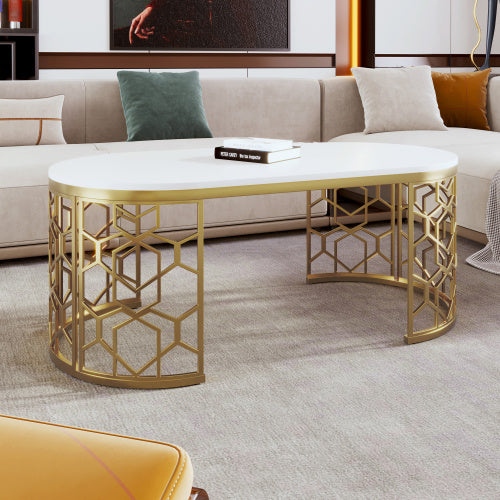 Elegant modern oval coffee table with gold stainless steel cut-out pattern frame and white MDF top.