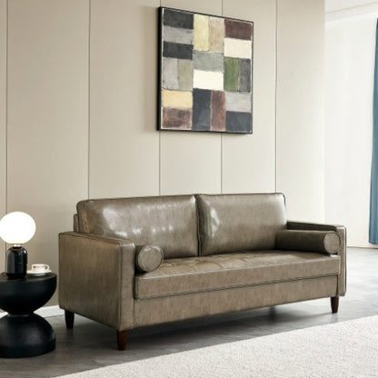 Modern mid-century khaki vegan leather sofa in a living room setting