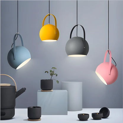 Colorful pendant lights with adjustable angles hanging from cords