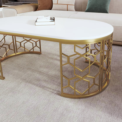 Elegant modern oval coffee table with gold stainless steel cut-out pattern frame and white MDF top.