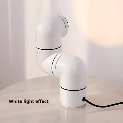 White Space Age Creative Water Pipe Lamp with rotating design illuminating a table.